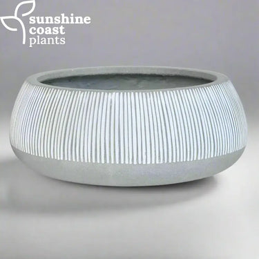 A modern Alpine bowl with a rounded form and vertical ribbed detailing, finished in soft grey and white